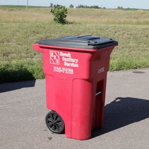 Image of red 65 gallon garbage cart from Novak Sanitary.
